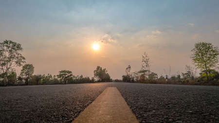 A country road with sunset in summer, Thailandの写真素材