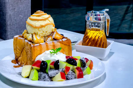 fruity honey toast with whipped cream and ice cream on place