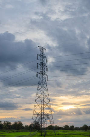 Single electic pole in front of beatiful sun settingの写真素材