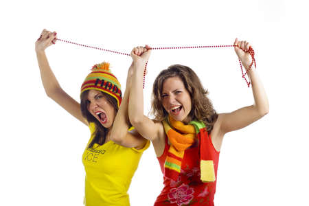 Two young women dancing with his hands raised up. Studio. The white background.の写真素材