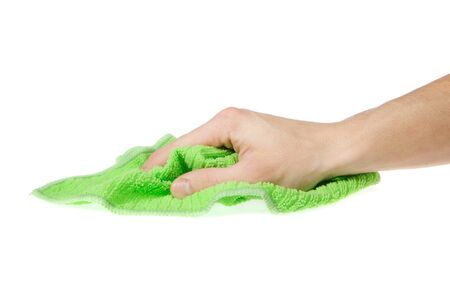 Hand with a green cloth wipe the surface isolated on white backgroundの写真素材