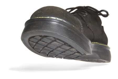 One black men's shoes with thick sole on a white background with shadow. Image taken low angle view.の写真素材