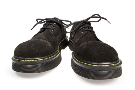 Black men's shoes on a white background with shadowの写真素材