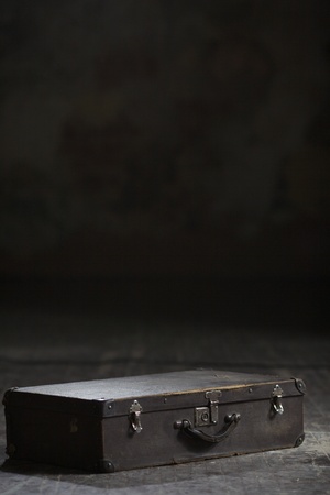 Image of old suitcase lying on the wooden floorの写真素材