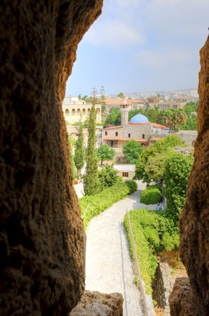 The historic city of  Byblos in Lebanon viewed from the arrow loop of the crusaders' castle. A view of the mosque and the path leading to the castle entrance.の写真素材