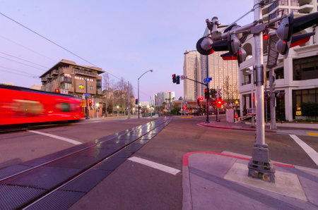 A street view of Downtown San Diego, California, USA, at night - dusk. A view of the transportation, city lights and skyscrapers and local buildings in the Marina's waterfront.のeditorial素材