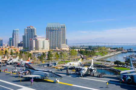 The historic aircraft carrier, USS Midway Museum moored in Broadway Pier in Downtown San Diego, Southern California, United States of America and the skyline. A battleship commissioned after the World War II.のeditorial素材
