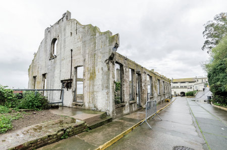 The Social Hall on Alcatraz island prison, now a museum in San Francisco, California, USA. A view of the stripped, burned, moldy walls and the ruins, a result of the native american occupation.のeditorial素材