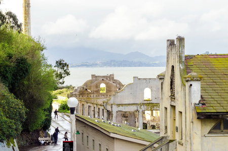 The Social Hall on Alcatraz island prison, now a museum in San Francisco, California, USA. A view of the stripped, burned, moldy walls and the ruins, a result of the native american occupation.のeditorial素材