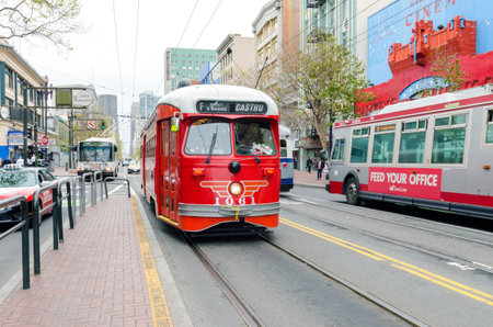 Market street in Downtown and South in San Francisco city, California, United States of America. A view of the MUNI bus leading to the Catro, the transport, shops, architecture, cable car lines and cityscapeのeditorial素材