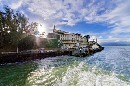 The Alcatraz Penitentiary, now a museum, in San Francisco, California, United States of America. A view of the island, the pier and wharf, prison buildings and the San Francisco Bay on a sunny day.のeditorial素材