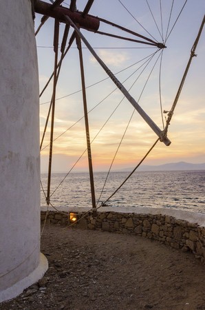 A windmill in Chora, Mykonos, Greece at sunset. Very traditional greek whitewashed architecture, a...