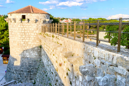 The round venetian tower of Frankopan Castle, at Kamplin square in Krk, Croatia - Frankopanski Kastel, part of the medieval city walls and conical canon openingsのeditorial素材