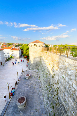 The round venetian tower of Frankopan Castle and the Kamplin square in Krk, Croatia - Frankopanski Kastel, part of the medieval city walls and now promenade.のeditorial素材