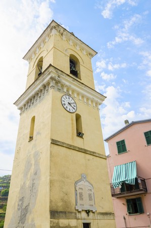 Manarola town, Riomaggiore, La Spezia province, Liguria, northern Italy. View of the San Lorenzo church defence bell tower, monument landmark. Part of the Cinque Terre National Park and a UNESCO World Heritage Site.の写真素材