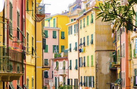 Riomaggiore village, La Spezia province, Liguria, northern Italy. View of the colourful houses on steep hills and laundry on balconies. Part of the Cinque Terre National Park and a UNESCO World Heritage Site.の写真素材