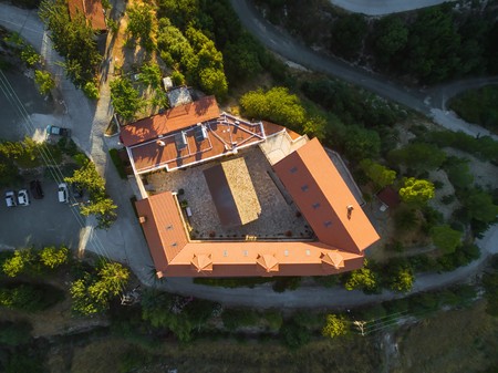 Aerial bird's eye view of christian greek orthodox Holy Monastery of Panayia Amasgous in Monagri...