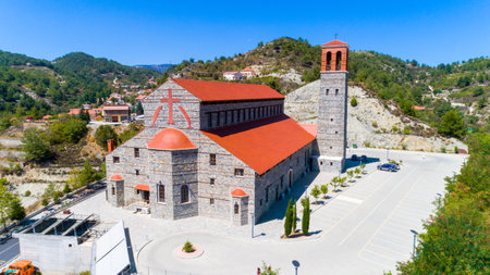 Aerial view of Agios Arsenios church, Kyperounda village, Limassol, Cyprus. Traditional landmark christian greek orthodox, ceramic tiled roof, stone bell tower architecture in Kyperounta from aboveのeditorial素材