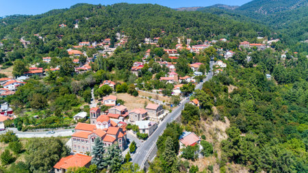 Aerial view of Pano Platres village,winter resort, on Troodos mountains, Limassol, Cyprus. Bird's eye view of pine tree forest, red roof tiled houses, hotels, panagias faneromenis church from above.のeditorial素材