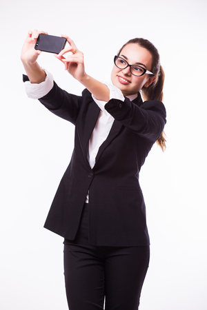 I love selfie! Portrait of a happy business lady blinking her eye while taking selfie with glassesの写真素材