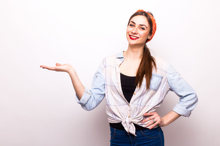 Portrait of a cheerful girl holding copyspace on the palm isolated on a white backgroundの写真素材