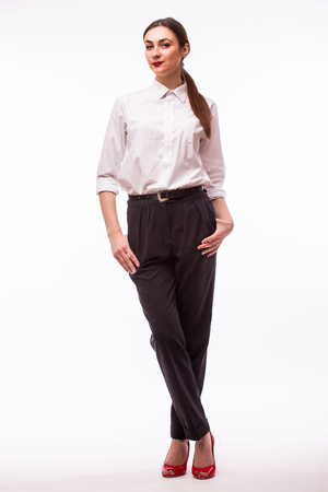 Confident business woman standing full length on white background.の写真素材