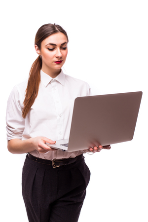 Happy young woman holding laptop and looking at camera over white backgroundの写真素材