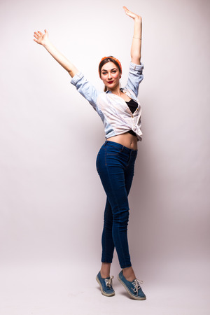 Very happy woman raising her arms and celebrating on white backgroundの写真素材