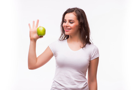 Girl demonstrate ok sigh with apple in handの写真素材