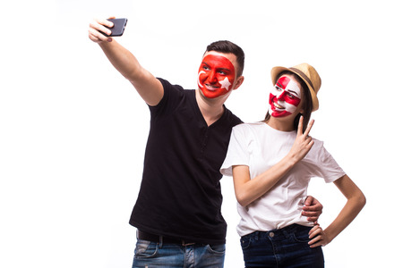 Selfie on phone of Turkey and Croatia football fans in game supporting of national teams on white background. European football fans concept.の写真素材