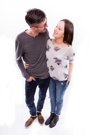 Happy young  hipster couple hugs at camera. Focuc from sky  isolated on a white background.の写真素材