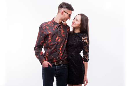 Hipster couple. Beautiful young loving couple posing while standing against white background.の写真素材
