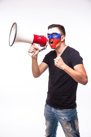 Scream on megaphone Russian football fan in game supporting of Russia national team on white background. European football fans concept.の写真素材