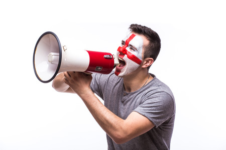 Scream on megaphone Englishman football fan in game supporting of England national team on white background. European football fans concept.の写真素材