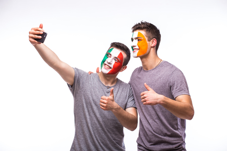 Italy vs Republic of Ireland football fans take selfie photo with phone on white background. European football fans concept.の写真素材