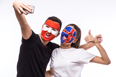 Iceland vs Austria football fans take selfie photo with phone on white background. European football fans concept.の写真素材