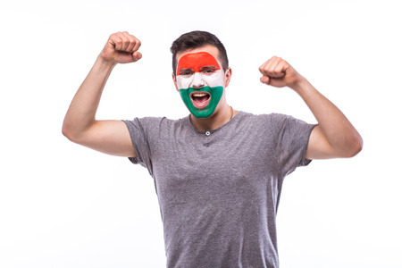 Victory, happy and goal scream emotions of Hungarian football fan in game support of Hungary national team on white background. European football fans concept.の写真素材