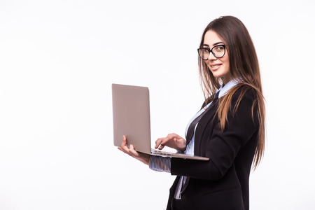 Happy businesswoman standing with laptop isolated on a white background.の写真素材