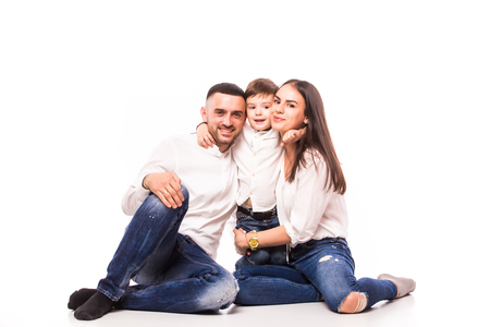 happy family mother and father with son sitting on the floor  on whiteの写真素材