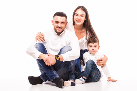 happy family mother, father and son sitting on the floor on whiteの写真素材