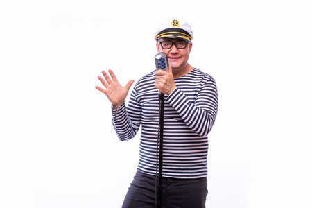Male sailor singer on microphone on white backの写真素材