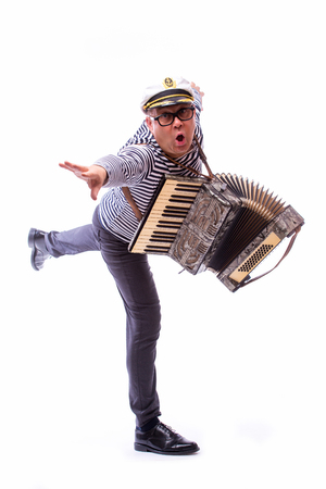 Sailor showman singer with musical instruments drum and accordion on white backの写真素材