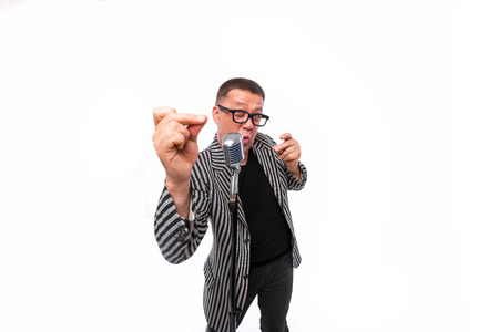 Portrait of artistic man singing in microphoneの写真素材