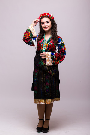 Portrait of cheerful Ukrainian girl wearing national embroidered shirt isolated on whiteの写真素材