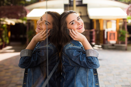 Young girl talk phone on the streetの写真素材