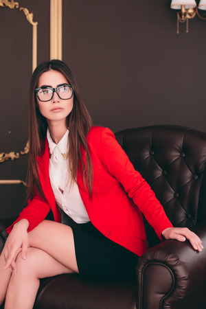 Young bussiness boss girl in chair waiting to interview peopleの写真素材
