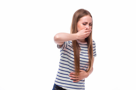 Closeup portrait of young unhappy, annoyed, sick woman about to chuck, throw up, retch barf, hurl isolated on white background.の写真素材