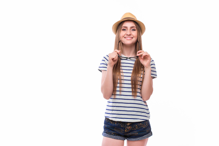 Young happy tourist  girl with hat and glasses on white backgrountの写真素材