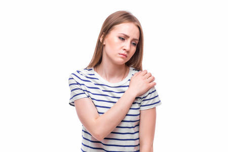 Acute pain in a woman elbow. Female is holding hand to spot of elbow pain indicating location of the pain. Isolation on a white background.の写真素材