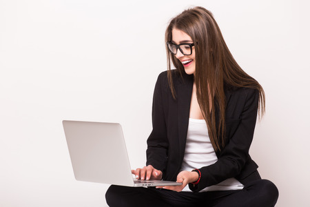 Business woman work on laptop in hands on white backgroundの写真素材